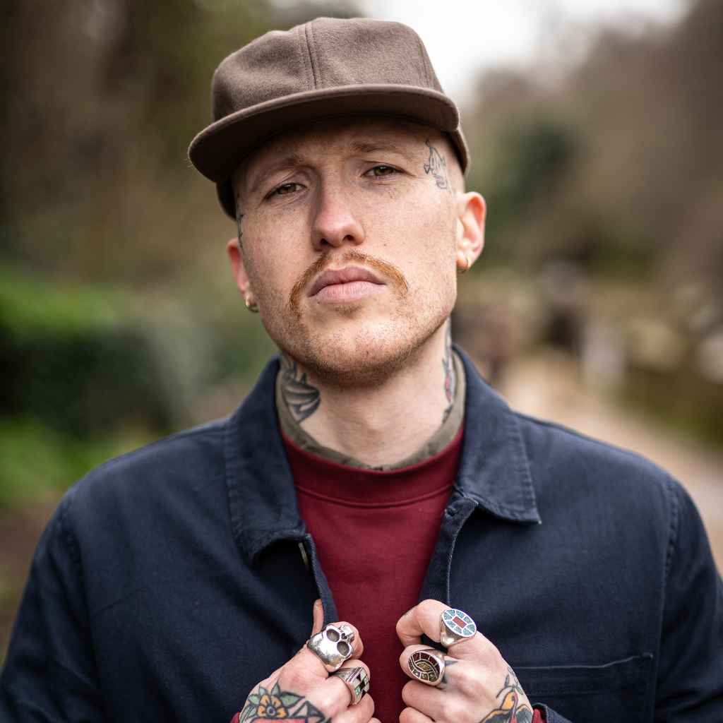 model wears paradaiza classic wool cap with burgundy sweat and worker jacket