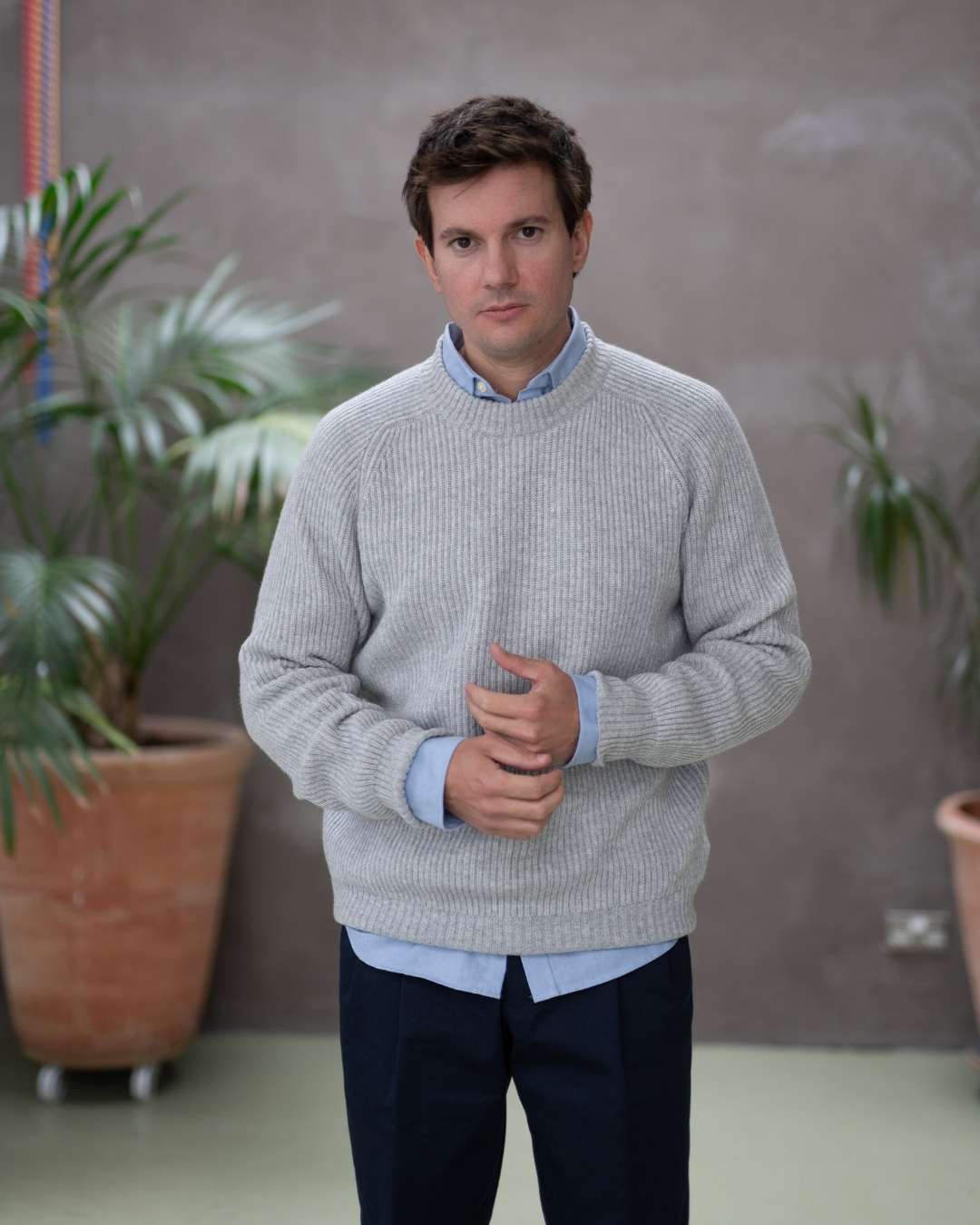 Model wearing a light grey paradaiza cashmere paradaiza knit and chinos 