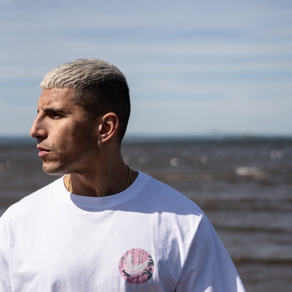 model wears paradaiza white tee at the beach