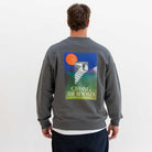 Person wearing a grey paradaiza sweatshirt with a colorful graphic and text on the back, on a white background