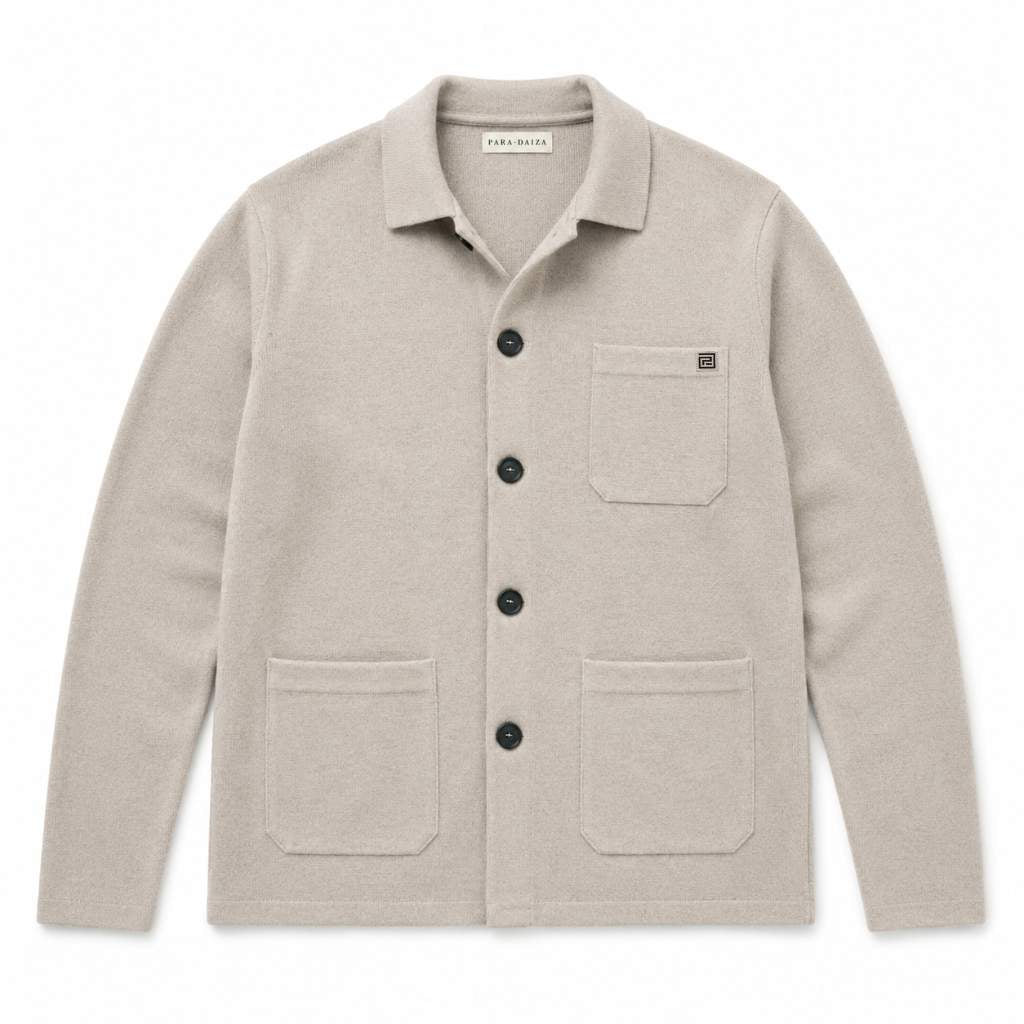 Paradaiza beige knitted worker jacket  with a collar, black buttons, a chest pocket, and two lower patch pockets, shown flat on a white background.