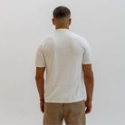 model wears a  Paradaiza Ivory  short-sleeve knitted polo shirt