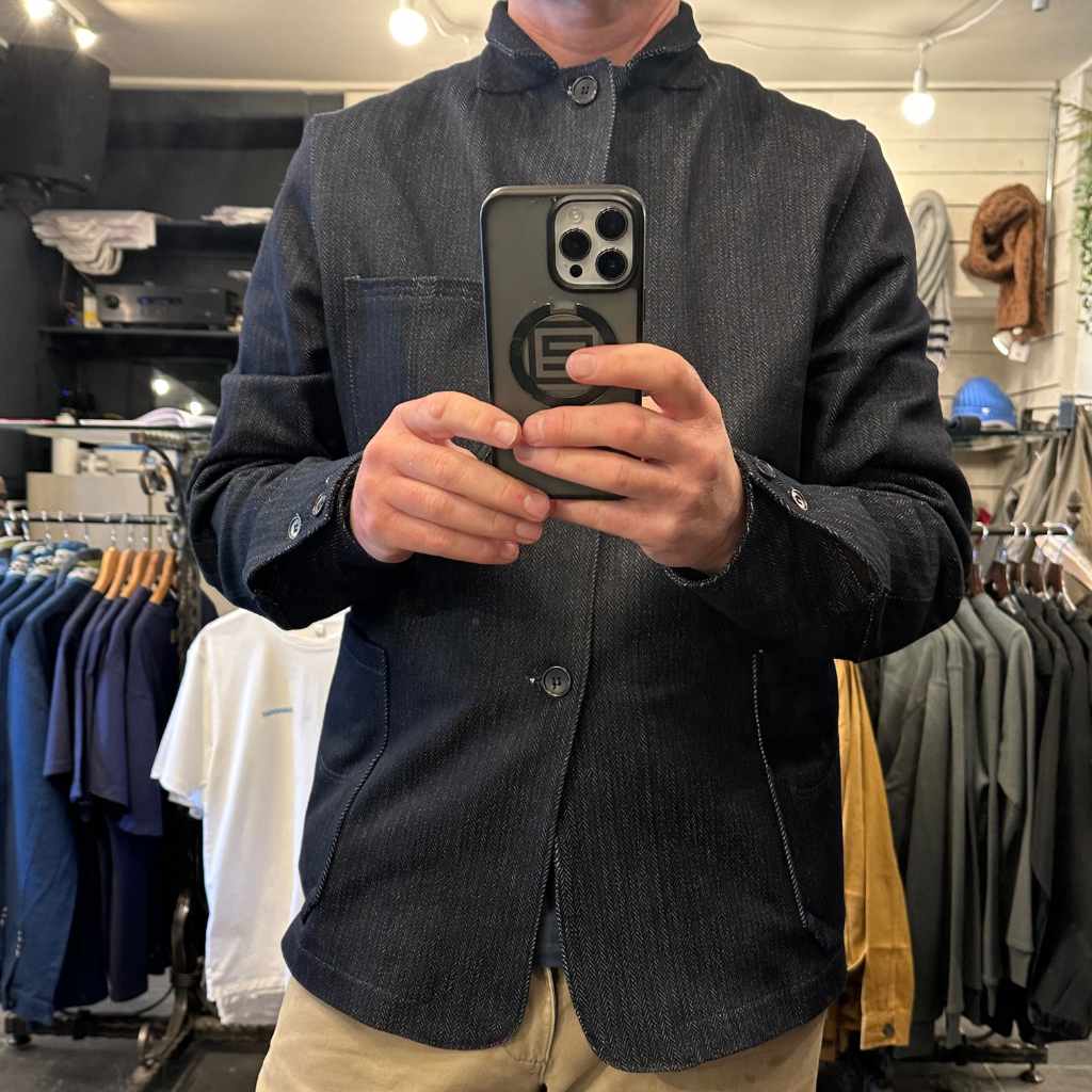 paul mullen wearing  a paradaiza rail worker jacket taking a mirror selfie in a the stockbridge store.