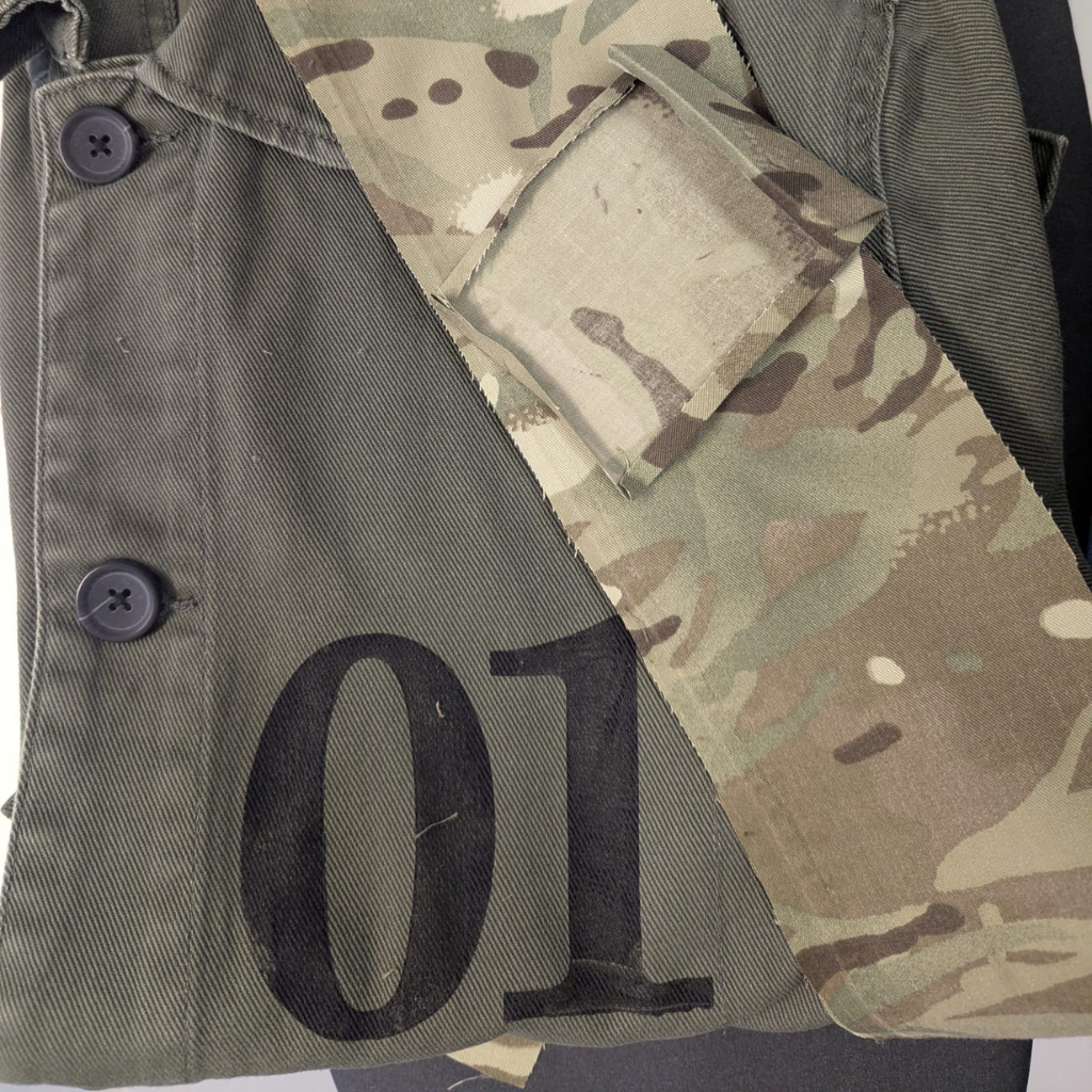 Khaki military-style PARA-DAIZA atelier jacket with camouflage pattern and number '01' on a white background