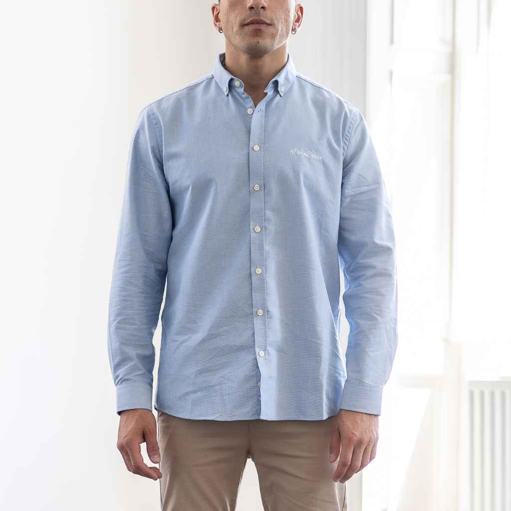 model wears paradaiza blue button down oxford shirt 