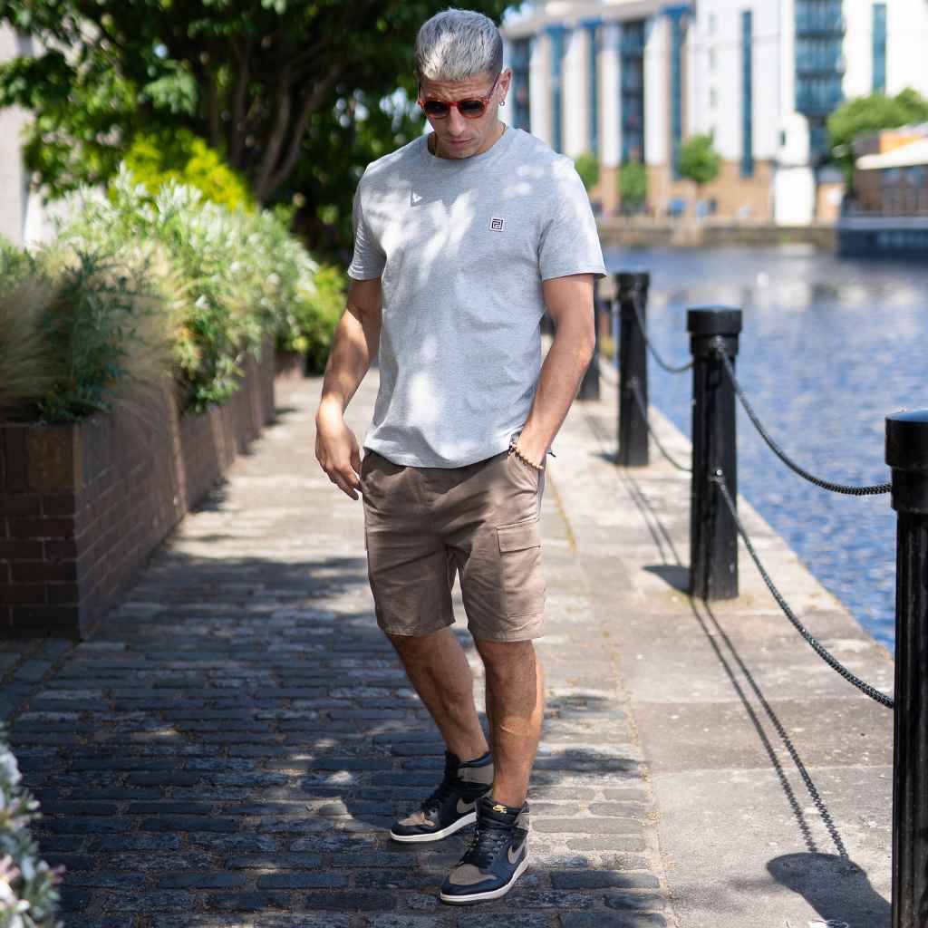 MODEL WEARS PARADAIZA GREY TEE AND CARGO SHORTS