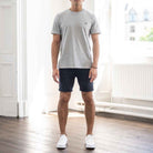 PARADAIZA MODEL WEARS GREY TEE NAVY CHINO SHORTS AND WHITE CANVAS SHOES