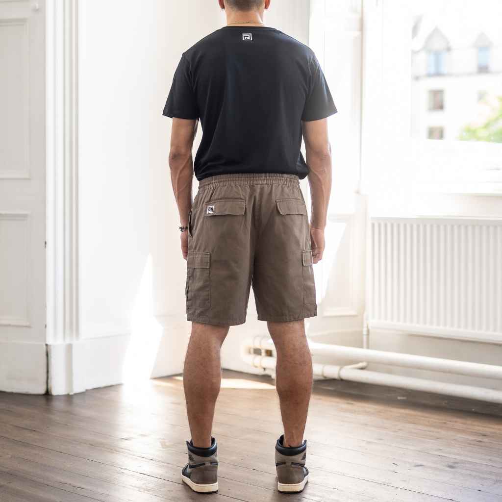 model wears paradaiza cargo shorts and graphic tee