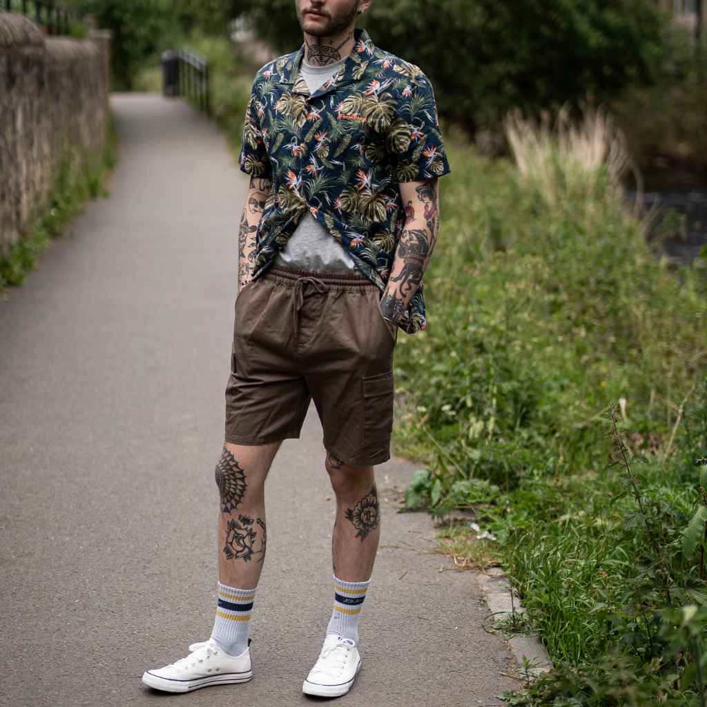 model wears paradaiza cargo shorts and  printed shirt 