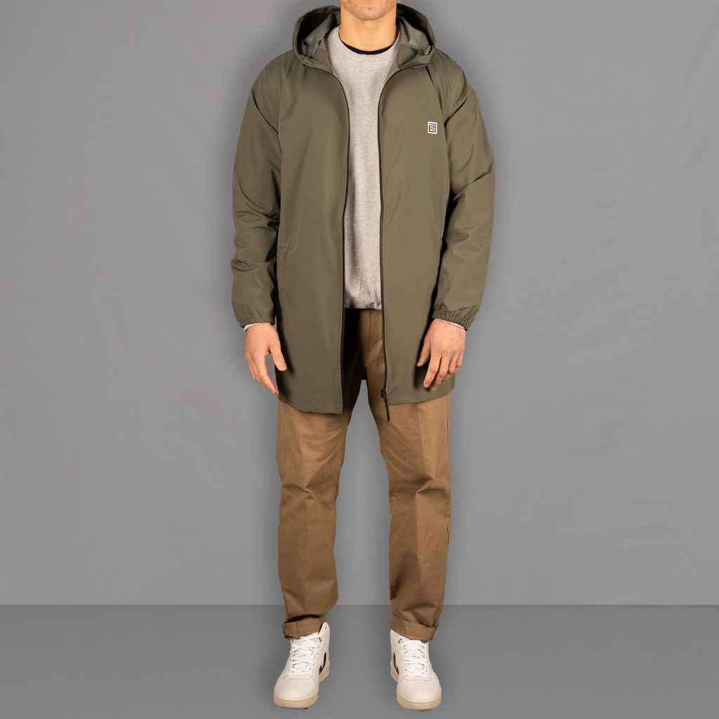 Model wears Para-Daiza Light weight Olive Parka Jacket and Tan Pinch Chinos, with Veja Sneakers