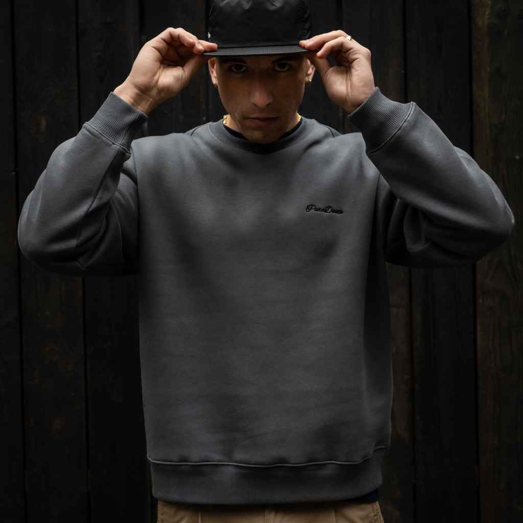 Model wears Para-Daiza Oversized Crew Sweat with “Just Common People Doing the Uncommon” moto text print  and  cap