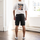 model wears paradaiza  black cargo shorts and tee 