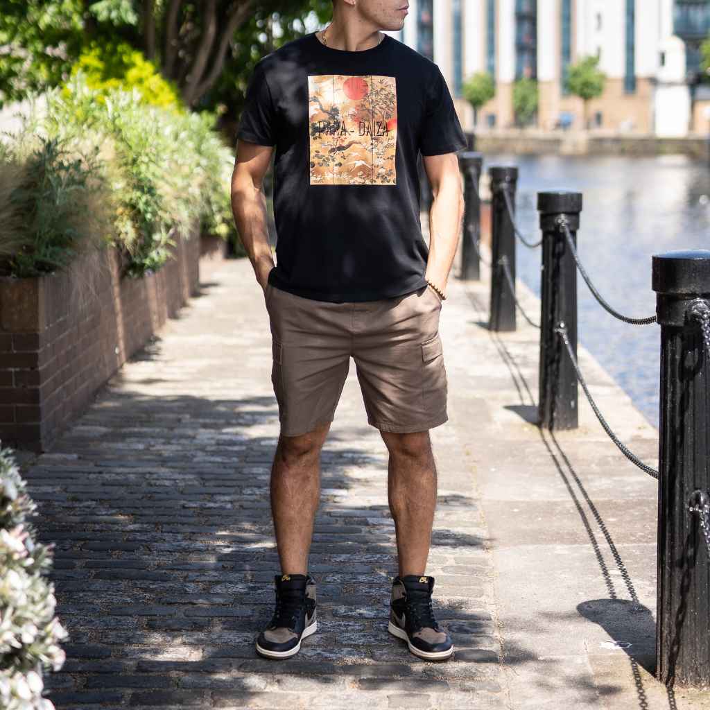 model wears paradaiza cargo shorts and graphic tee