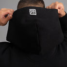 model wears Oversized black hooded sweatshirt with para-daiza brand logo on hood