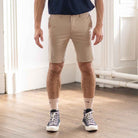 paradaiza model wears blue shirt beige shorts and white canvas shoes