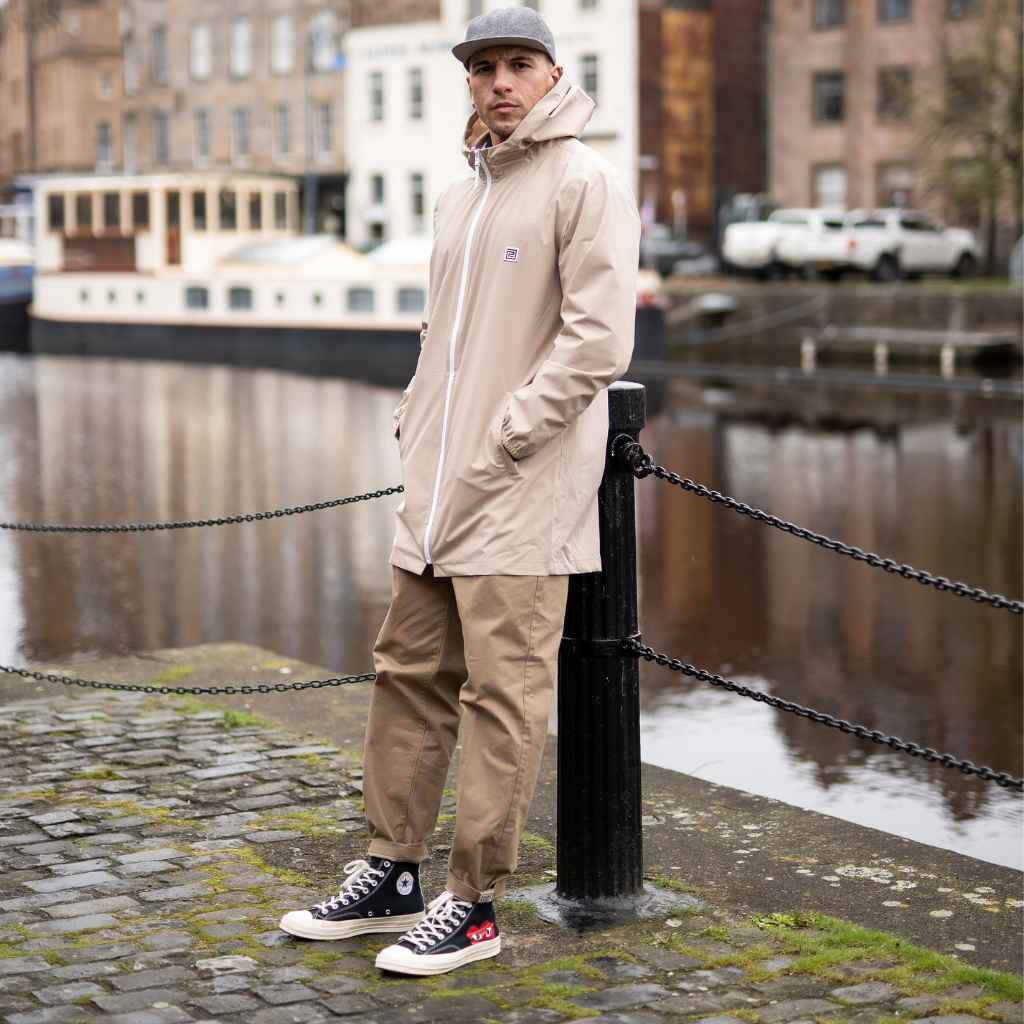 model wears paradaiza parka in sand  with pinch chinos