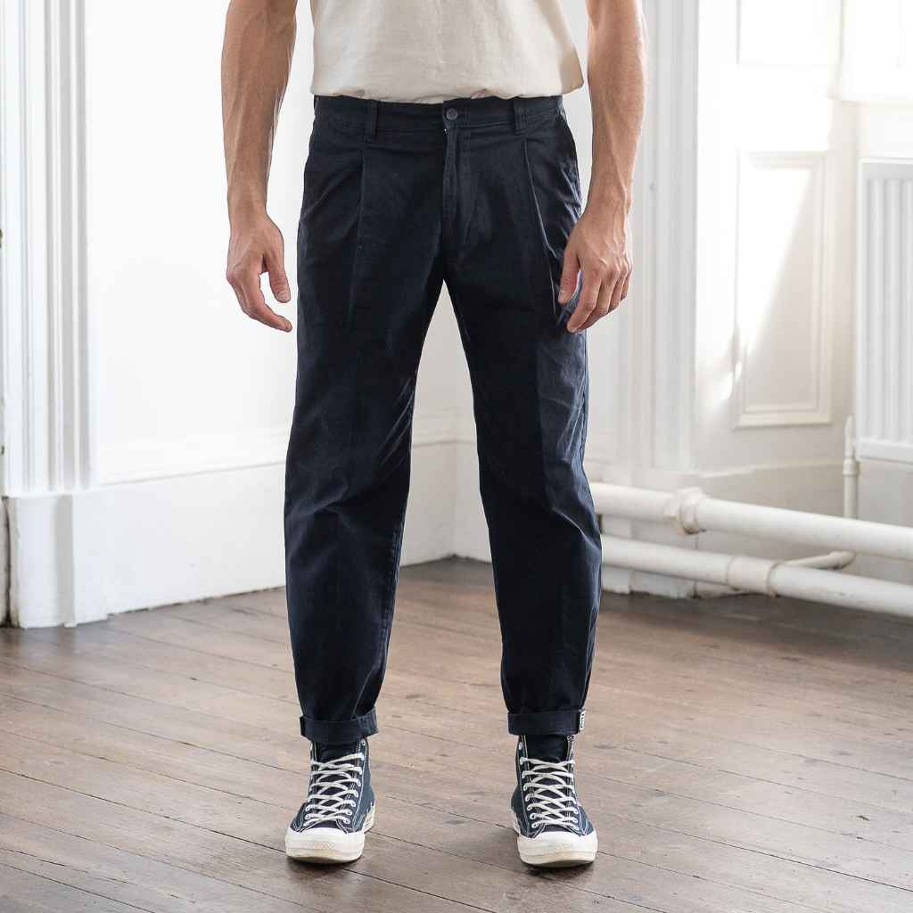 model wears paradaiza pinch tapered chinos  with com des garcon coverse