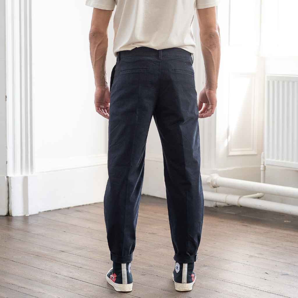 model wears paradaiza pinch tapered chinos  with com des garcon coverse