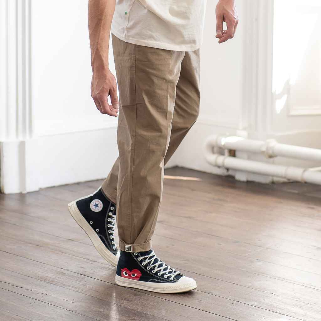 model wears paradaiza pinch tapered chino with com des garcon converse