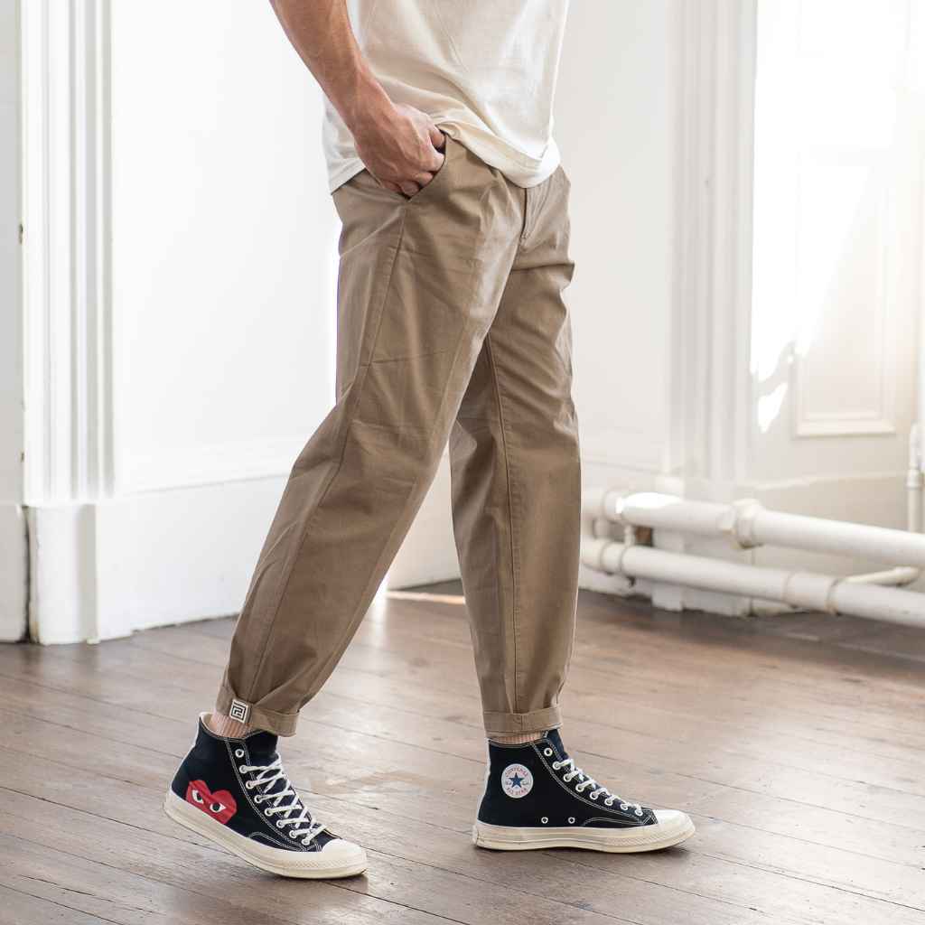 model wears paradaiza pinch tapered chino with com des garcon converse