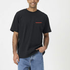 Man wearing a black t-shirt with 'Paradise' logo on a white background