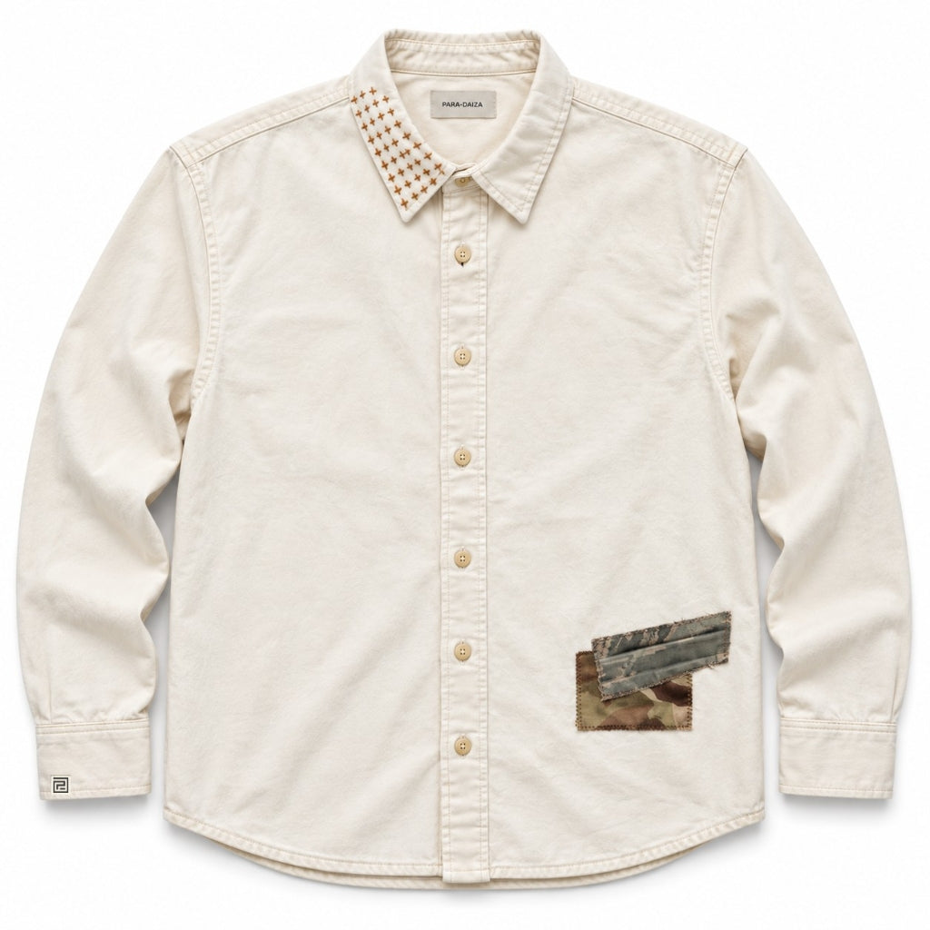 An off-white long-sleeve button-up shirt by Para Daiza, featuring a unique patterned collar with sashiko, a camouflage print pocket patch on the lower right front, and matching camouflage accents on the button placket.