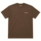 A brown short-sleeve crewneck t-shirt with a small white cursive logo on the left chest, displayed flat against a solid white background.
