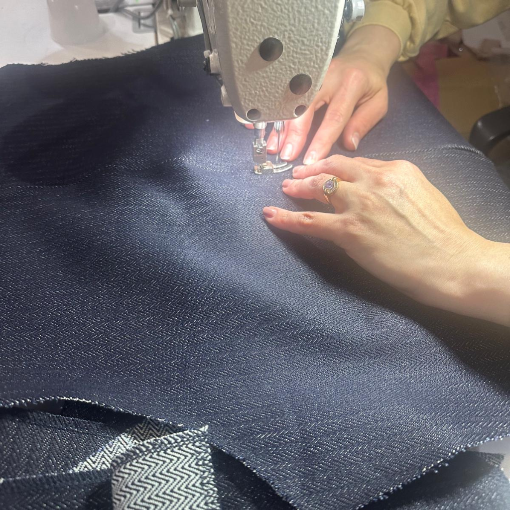 Person sewing orta denim fabric with a sewing machine