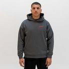 Man wearing a grey paradaiza hoodie with a red logo on a white background