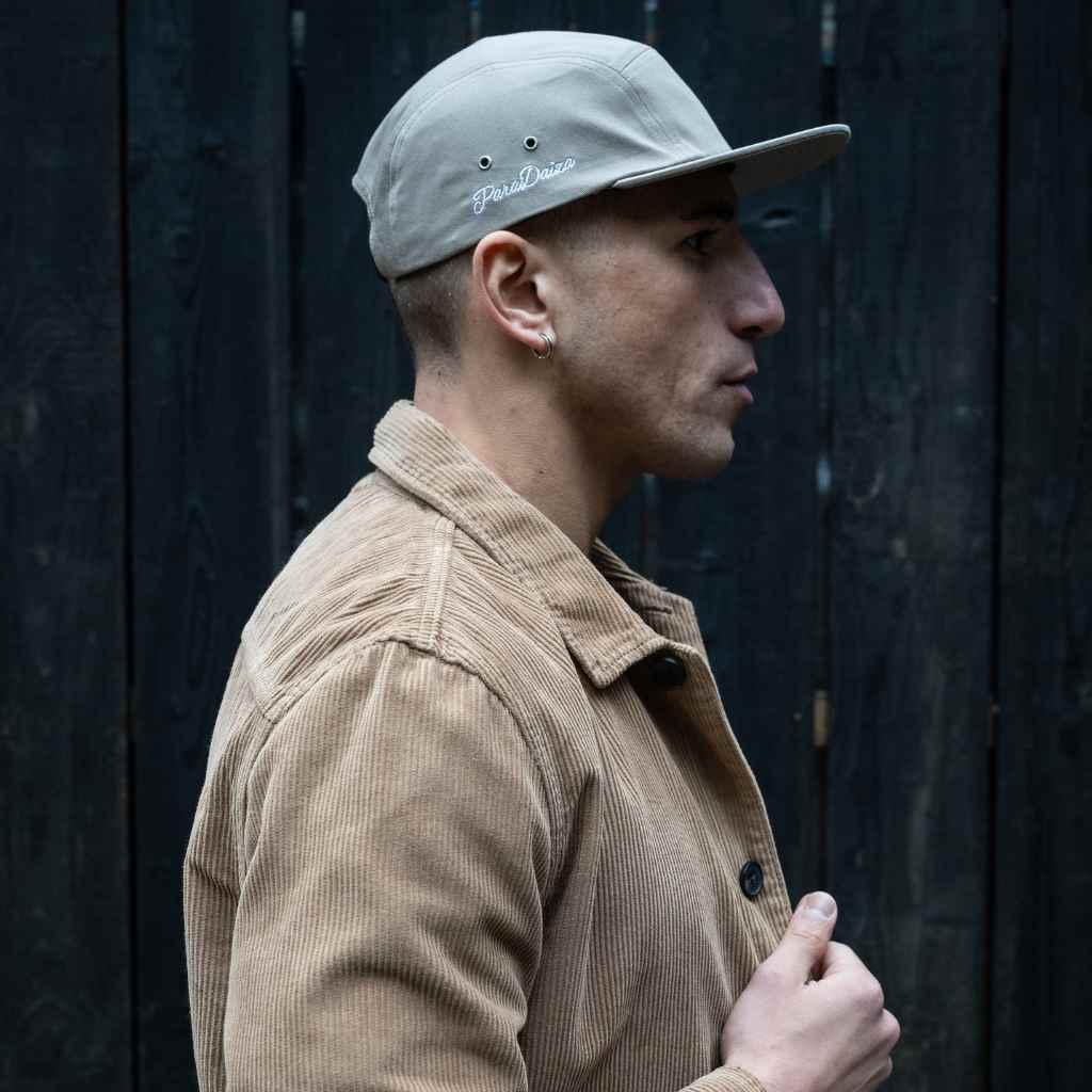 model wears  paradaiza 5 panel tan cap and cord shirt