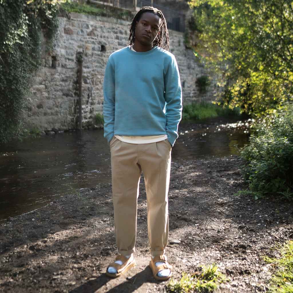 model wears blue paradaiza sweat and chinos with birkenstock sandals