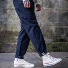 model wears apara-daiza navy chino and converse