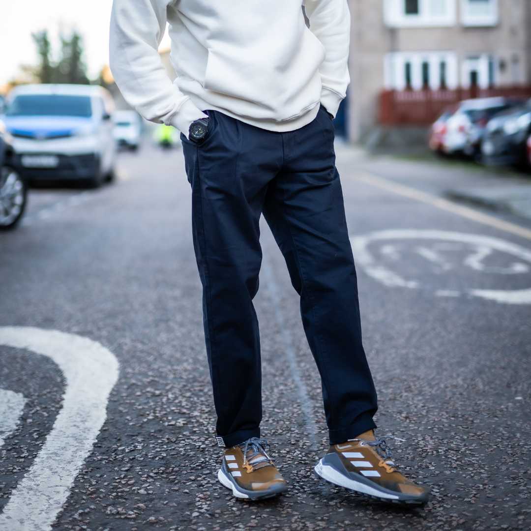 model wears para-daiza navy chino and adidas sneakers