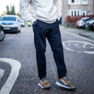 model wears para-daiza navy chino and adidas sneakers