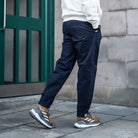 model wears para-daiza navy chino and adidas sneakers