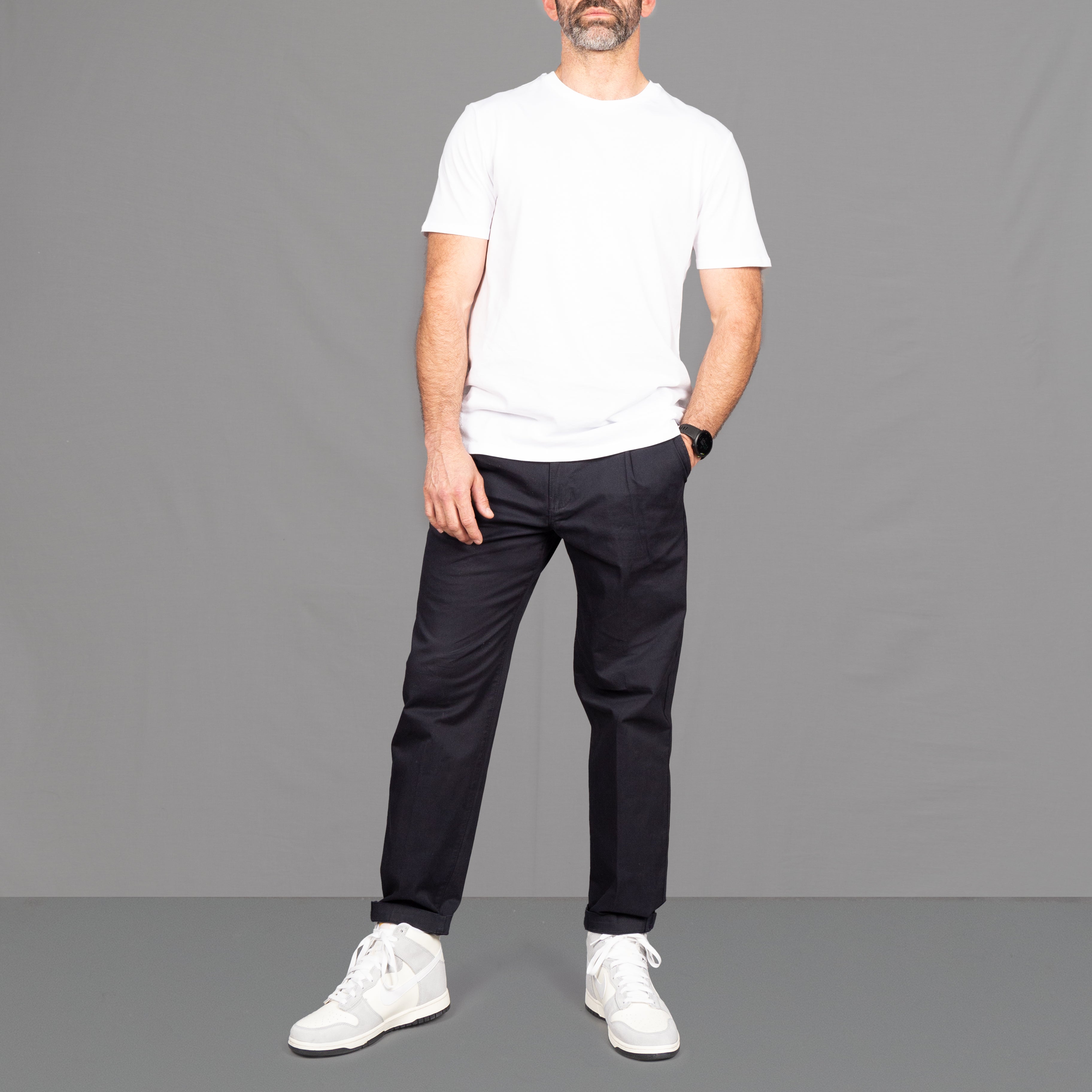 model wears core white t-shirt and navy chinos 