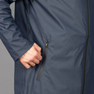 model wears a navy waterproof parka and chinos