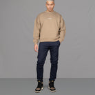 Model wears Para-Daiza Oversized Tan Crew neck sweatshirt  superflex chino, and Nike trainers. 