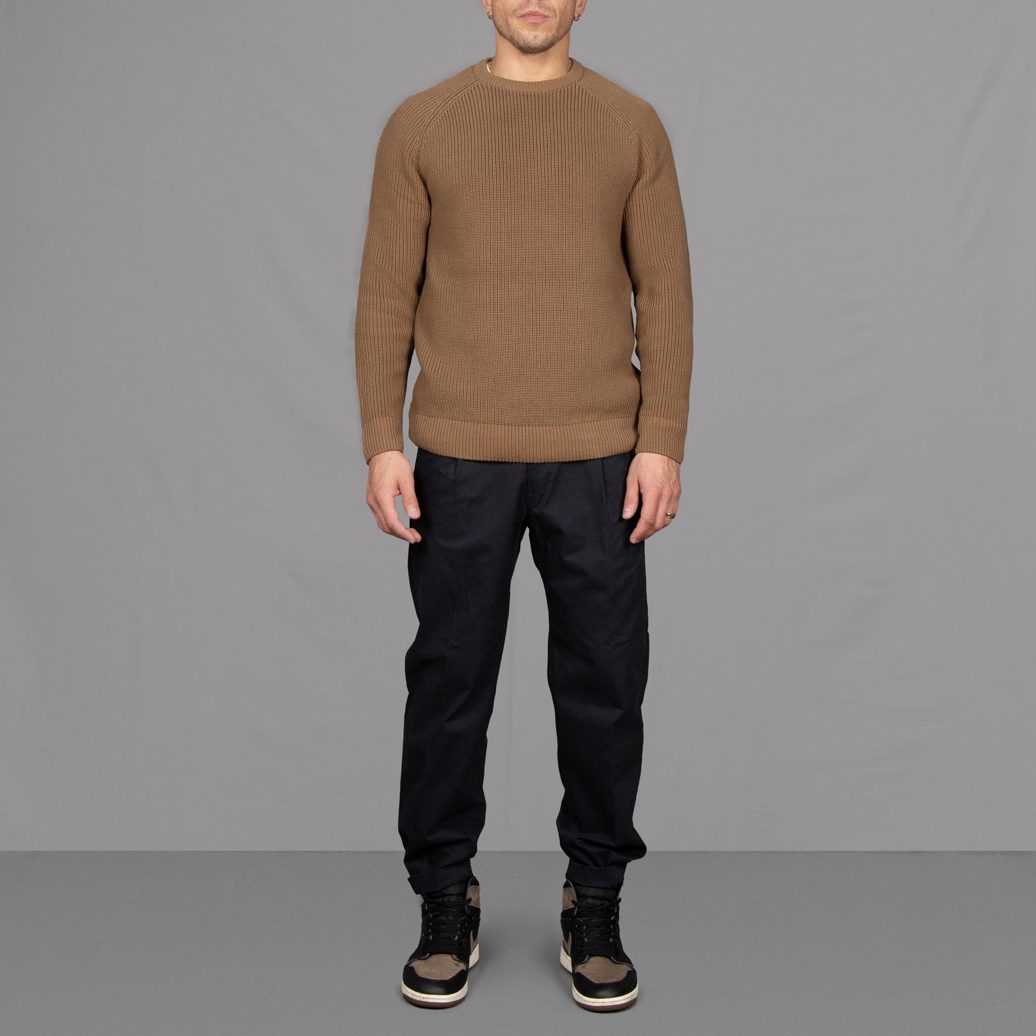 Model wears a paradaiza fishermans knit and pinch chinos, with Nikes 