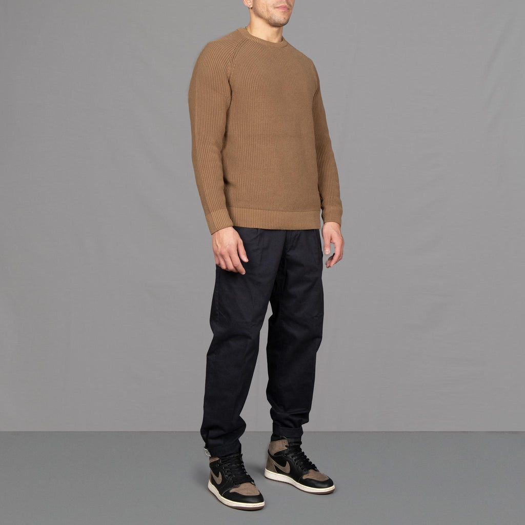 Model wears a paradaiza fishermans knit and pinch chinos, with Nikes