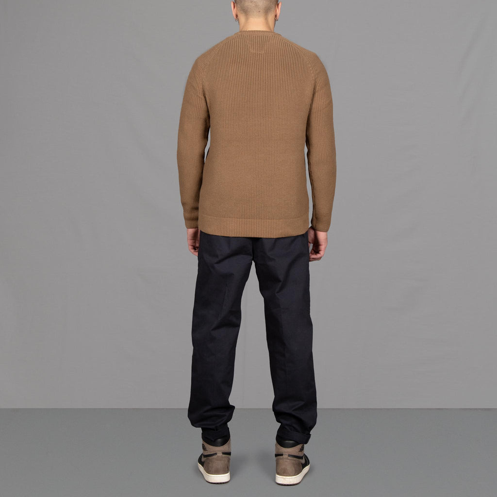 Model wears a paradaiza fishermans knit and pinch chinos, with Nikes