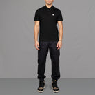 The model wears Para-Daiza Black Core Polo Shirt, pinch chino and Nike trainers.