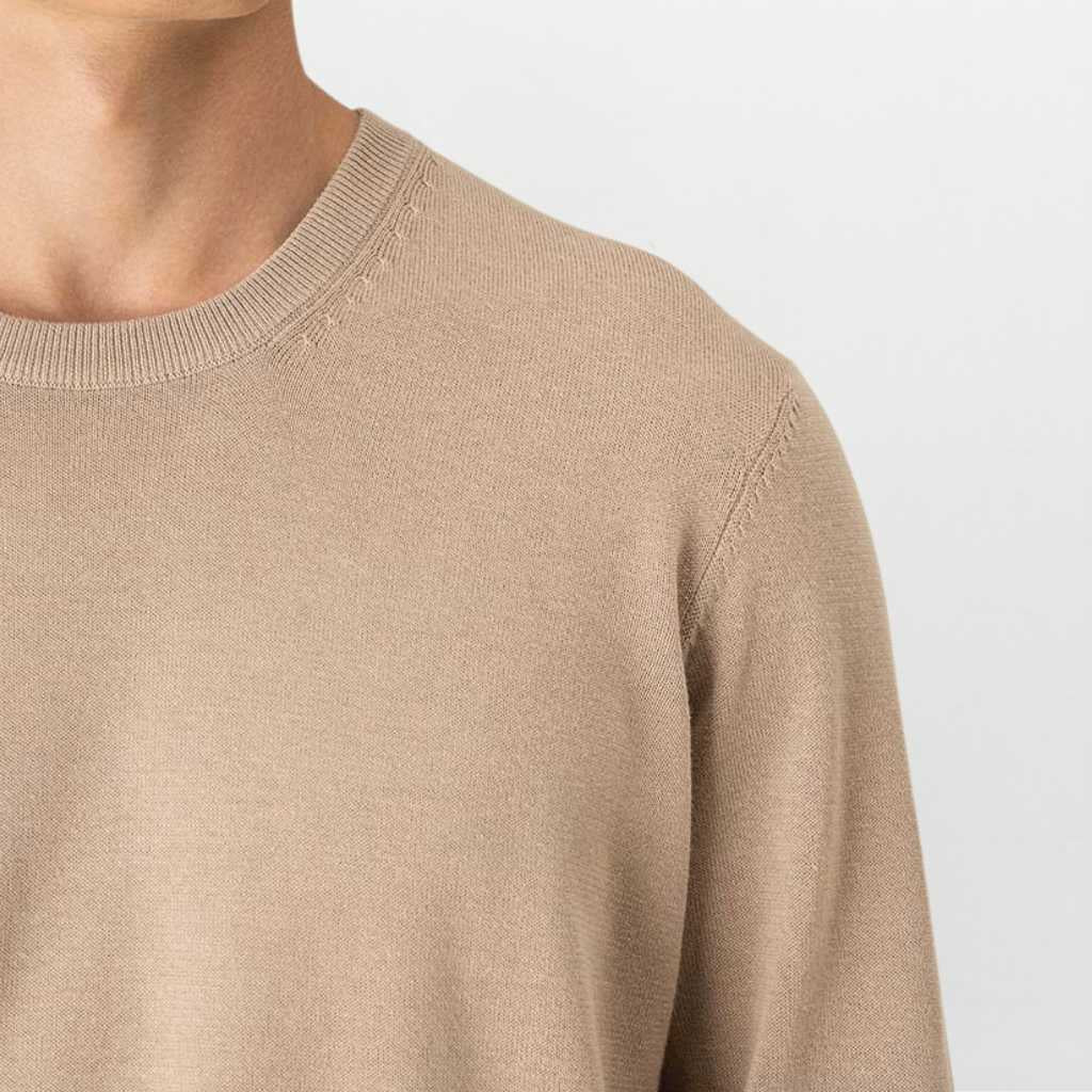 Paradaiza beige sweater worn by a person on a light gray background