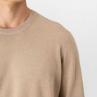Paradaiza beige sweater worn by a person on a light gray background