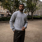 Model wearing a light grey paradaiza cashmere paradaiza knit and chinos 