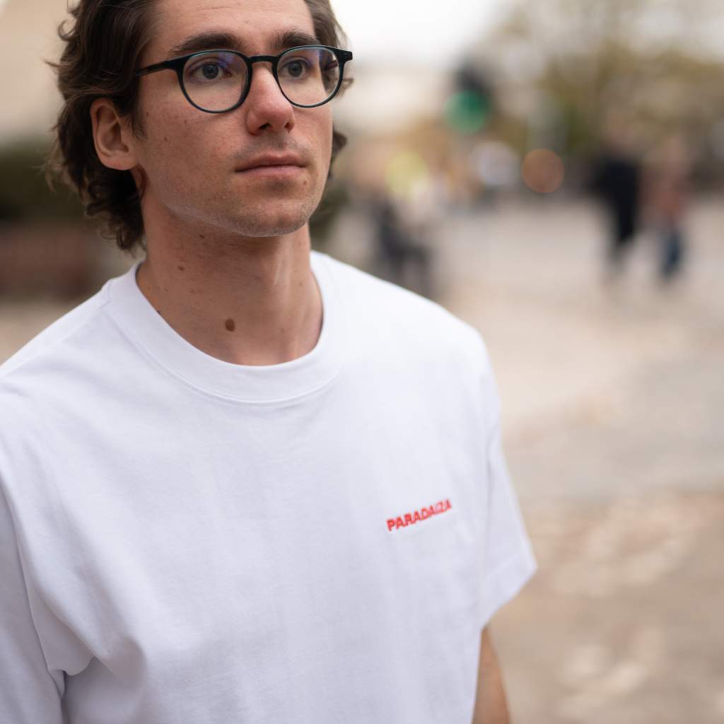 Paradaiza White t-shirt with a graphic design on the back on a model