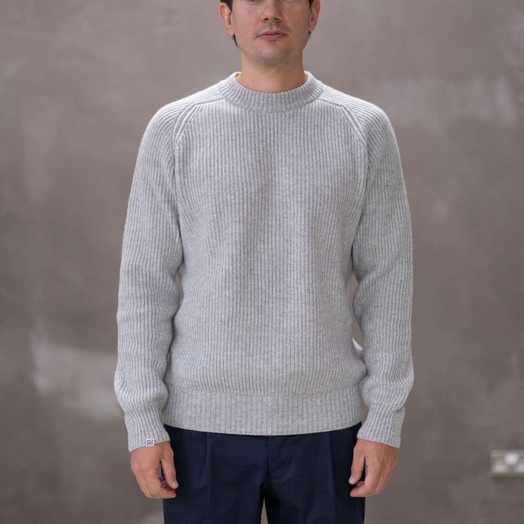 Model wearing a light grey paradaiza cashmere paradaiza knit and chinos 
