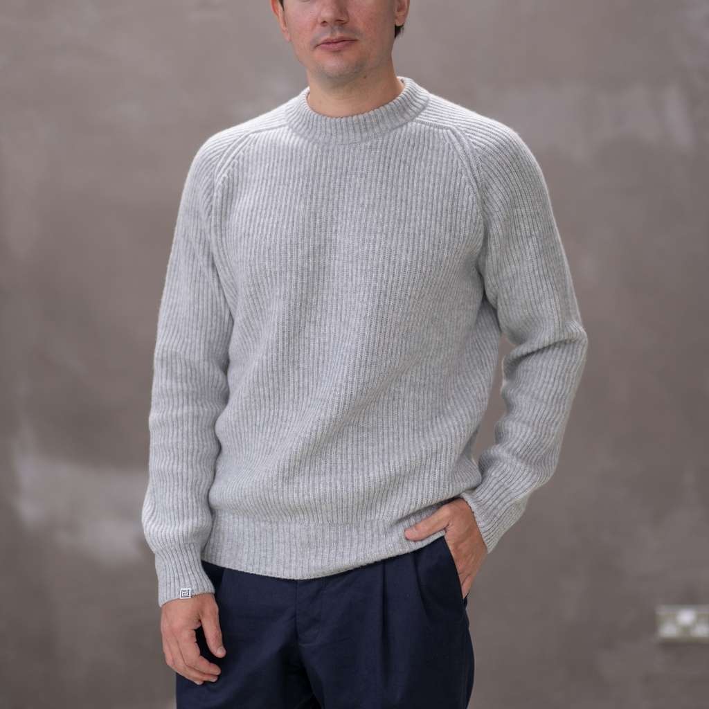 Model wearing a light grey paradaiza cashmere paradaiza knit and chinos 