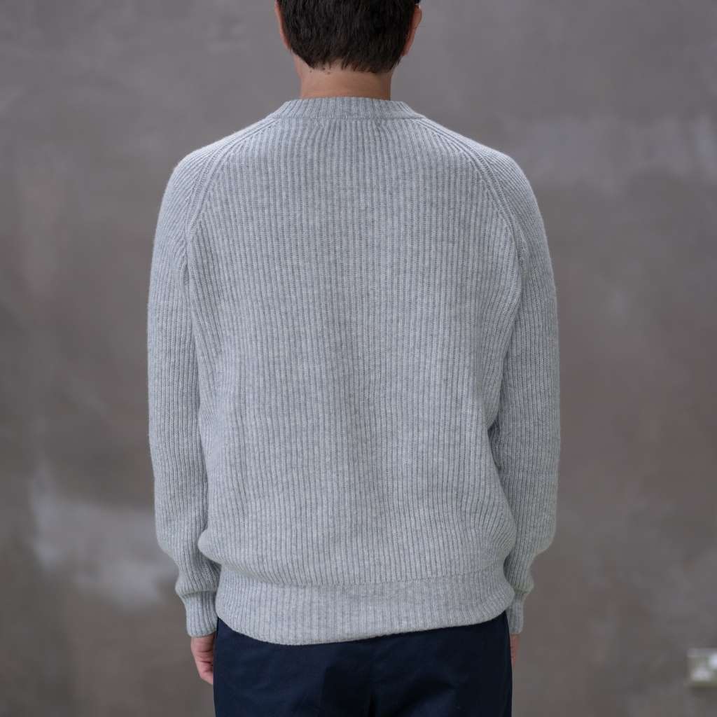 Model wearing a light grey paradaiza cashmere paradaiza knit and chinos 