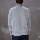Model wearing a light grey paradaiza cashmere paradaiza knit and chinos 
